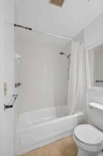 a bathroom with a shower and a toilet