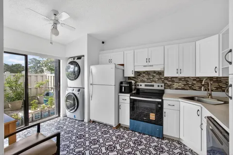 a kitchen with a stove a refrigerator and a stove top oven