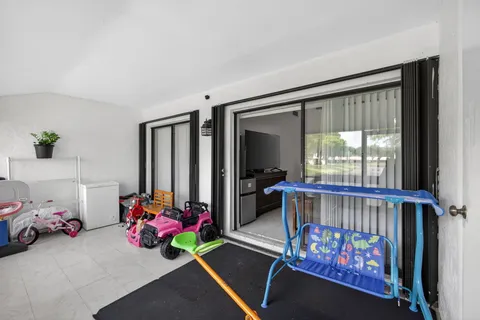 a living room with a baby crib furniture and a window