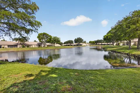 a view of a lake with houses in the back