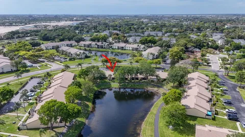 an aerial view of a house with a garden and lake view