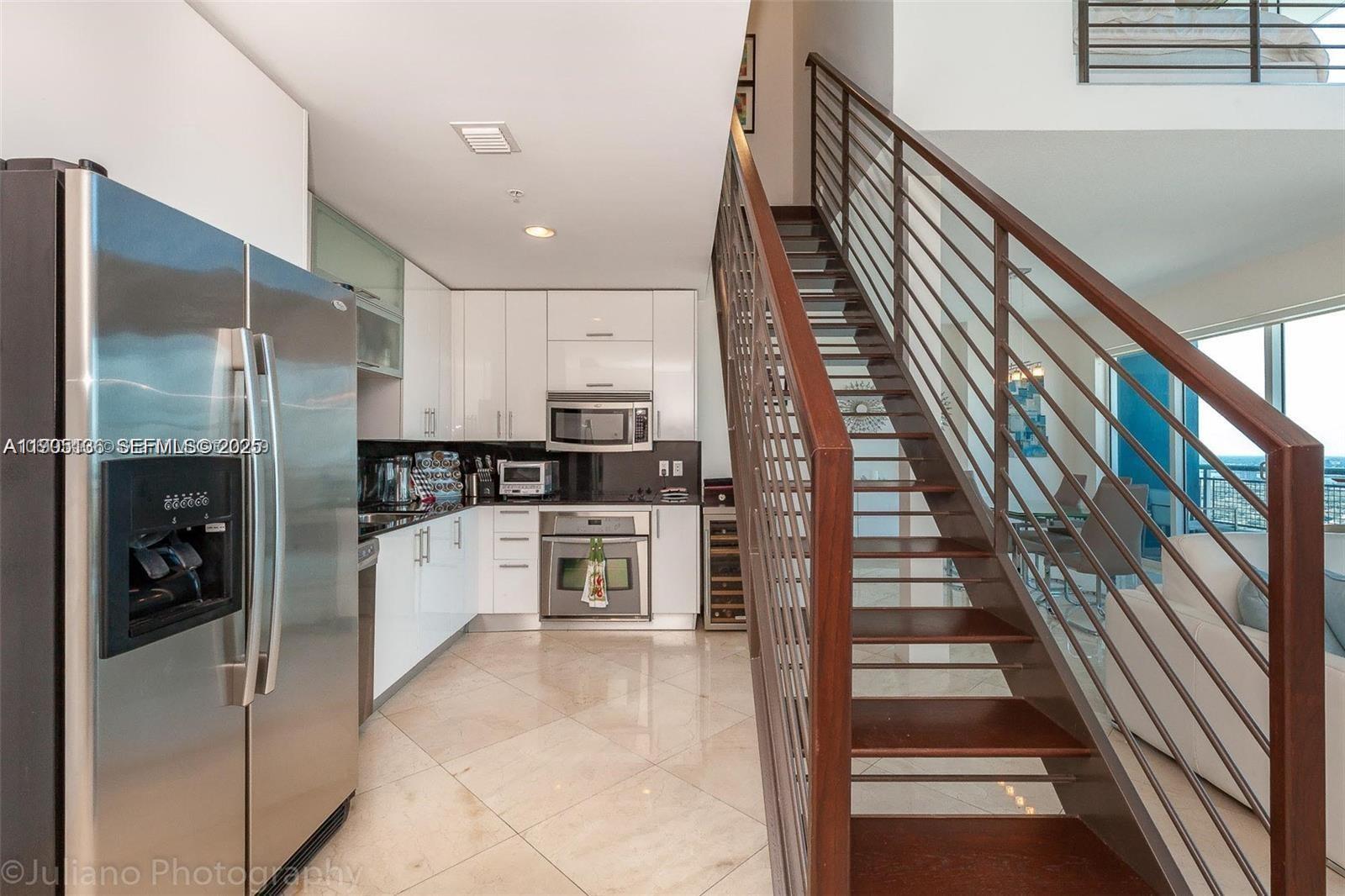 60 Southwest 13th Street, Unit 4205 Miami, FL 33130 - Photo 5 of 14 a kitchen with stainless steel appliances kitchen island granite countertop a refrigerator and a sink