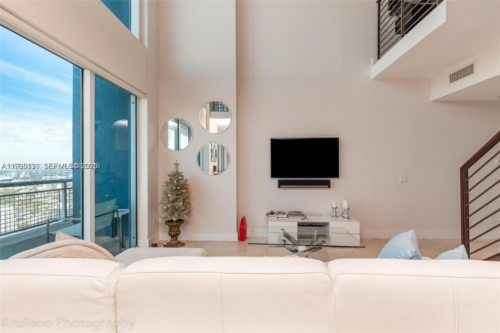 60 Southwest 13th Street, Unit 4205 Miami, FL 33130 - Photo 7 of 14 a bedroom with a bed and a flat screen tv