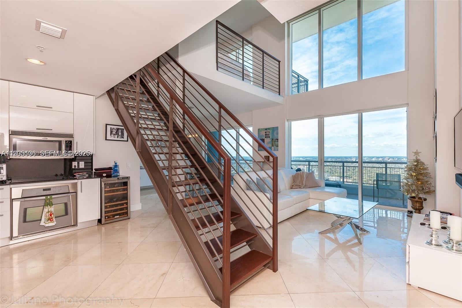 60 Southwest 13th Street, Unit 4205 Miami, FL 33130 - Photo 8 of 14 a view of an entryway with floor to ceiling windows and living room