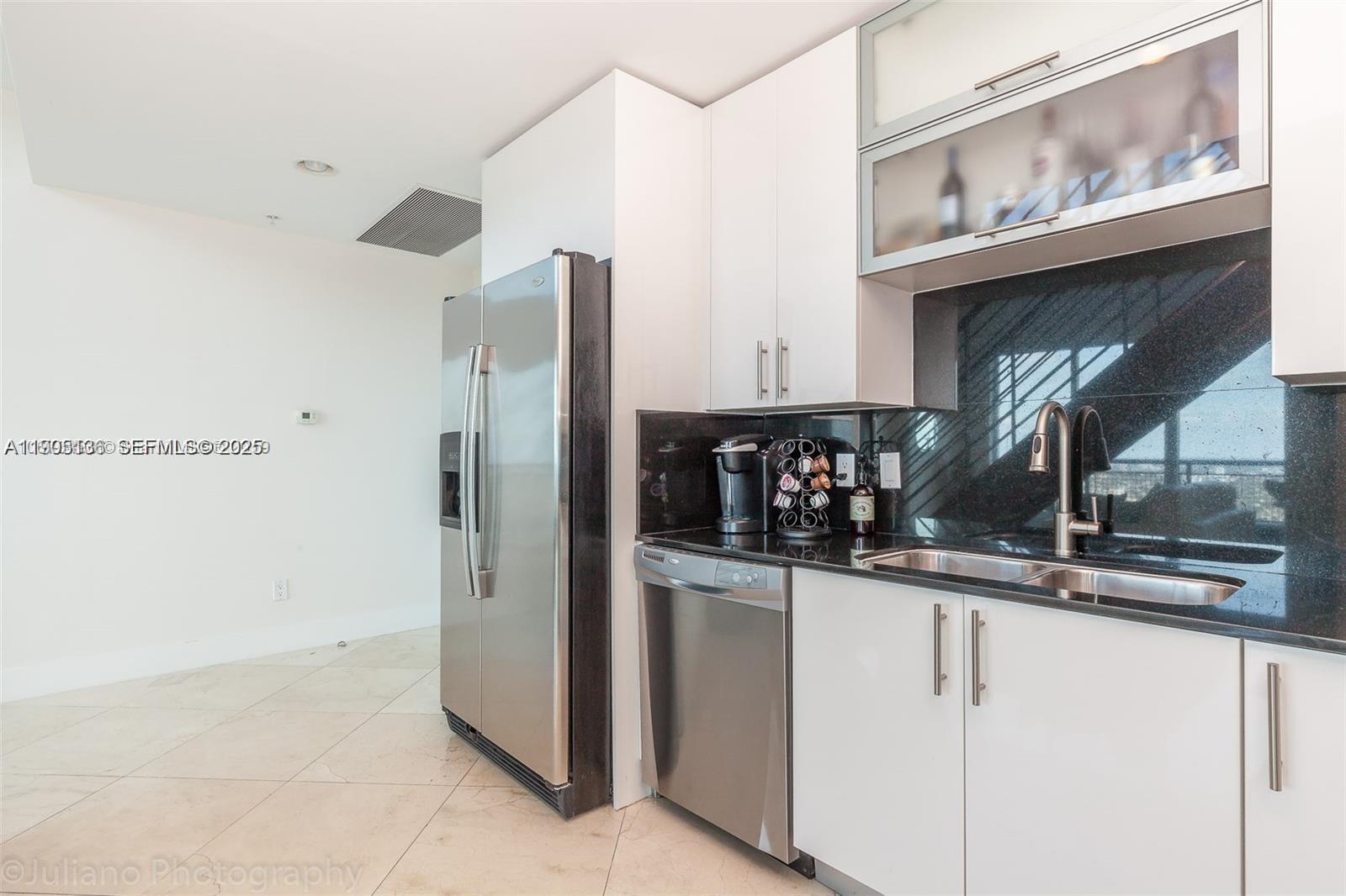 60 Southwest 13th Street, Unit 4205 Miami, FL 33130 - Photo 9 of 14 a kitchen with stainless steel appliances granite countertop a refrigerator and a sink