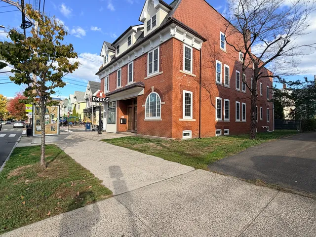 a front view of a building with a garden