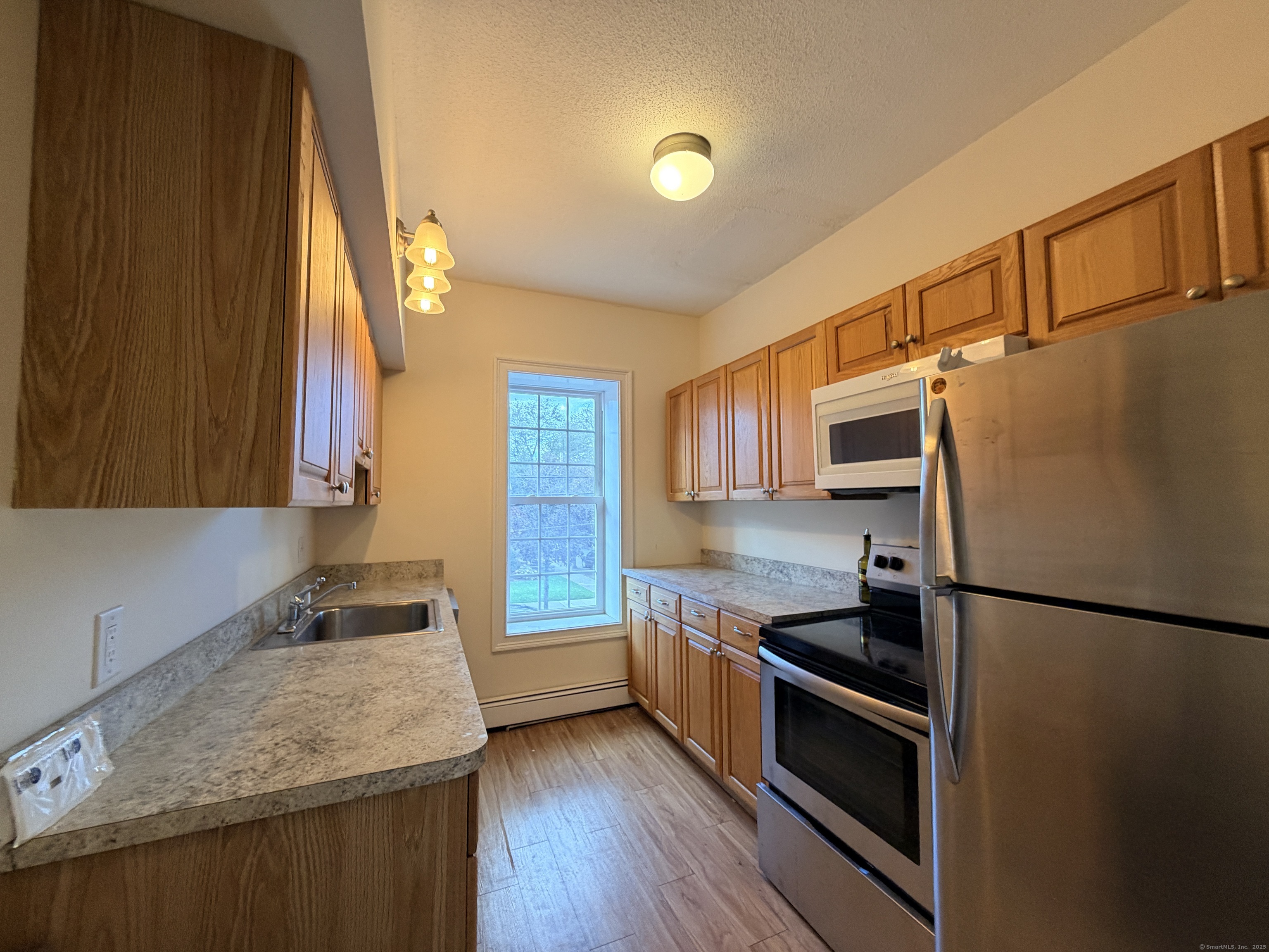 765 Orange Street, Unit 1 New Haven, CT 06511 - Photo 4 of 11 a kitchen with granite countertop a refrigerator stove and sink