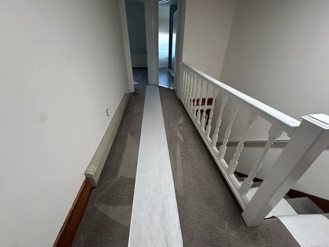 a bathroom with a glass door shower a sink and mirror