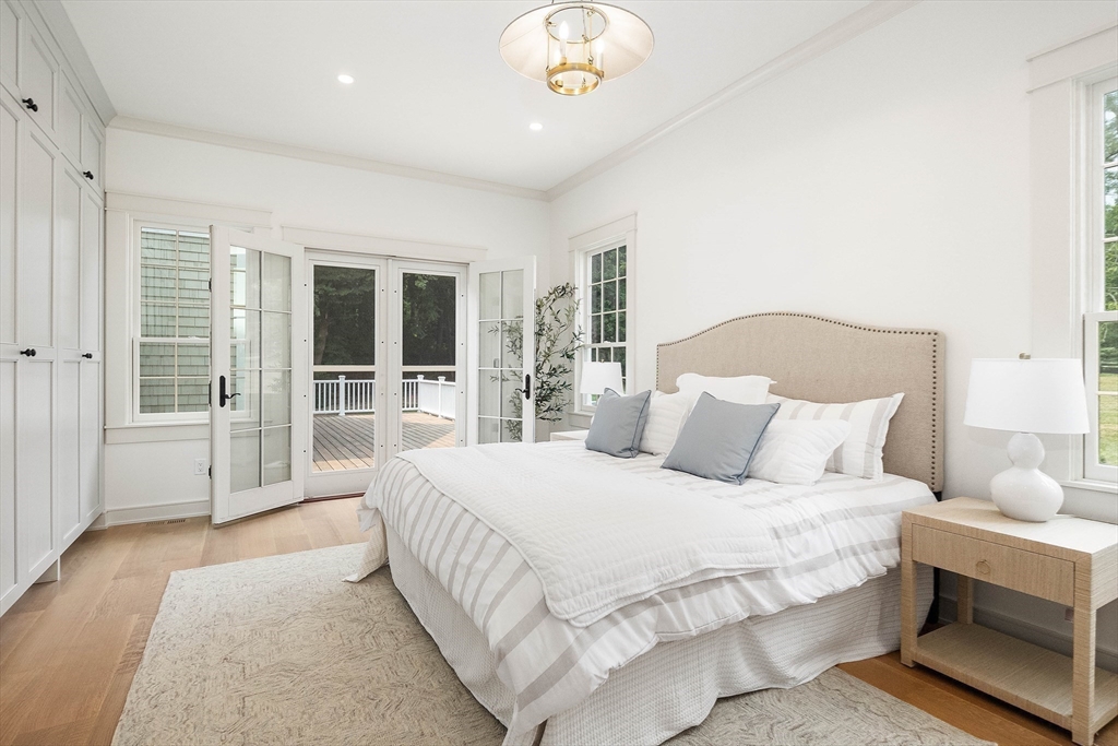 3 Home Meadows Lane Hingham, MA 02043 - Photo 9 of 19 a spacious bedroom with a large bed and a chandelier