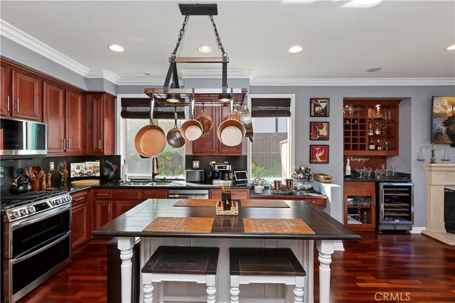 a living room with furniture a chandelier and a fireplace