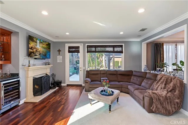 a view of a house with pool lawn chairs and a yard with potted plants