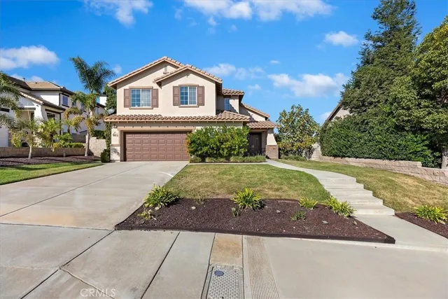 a living room with furniture a chandelier and a window