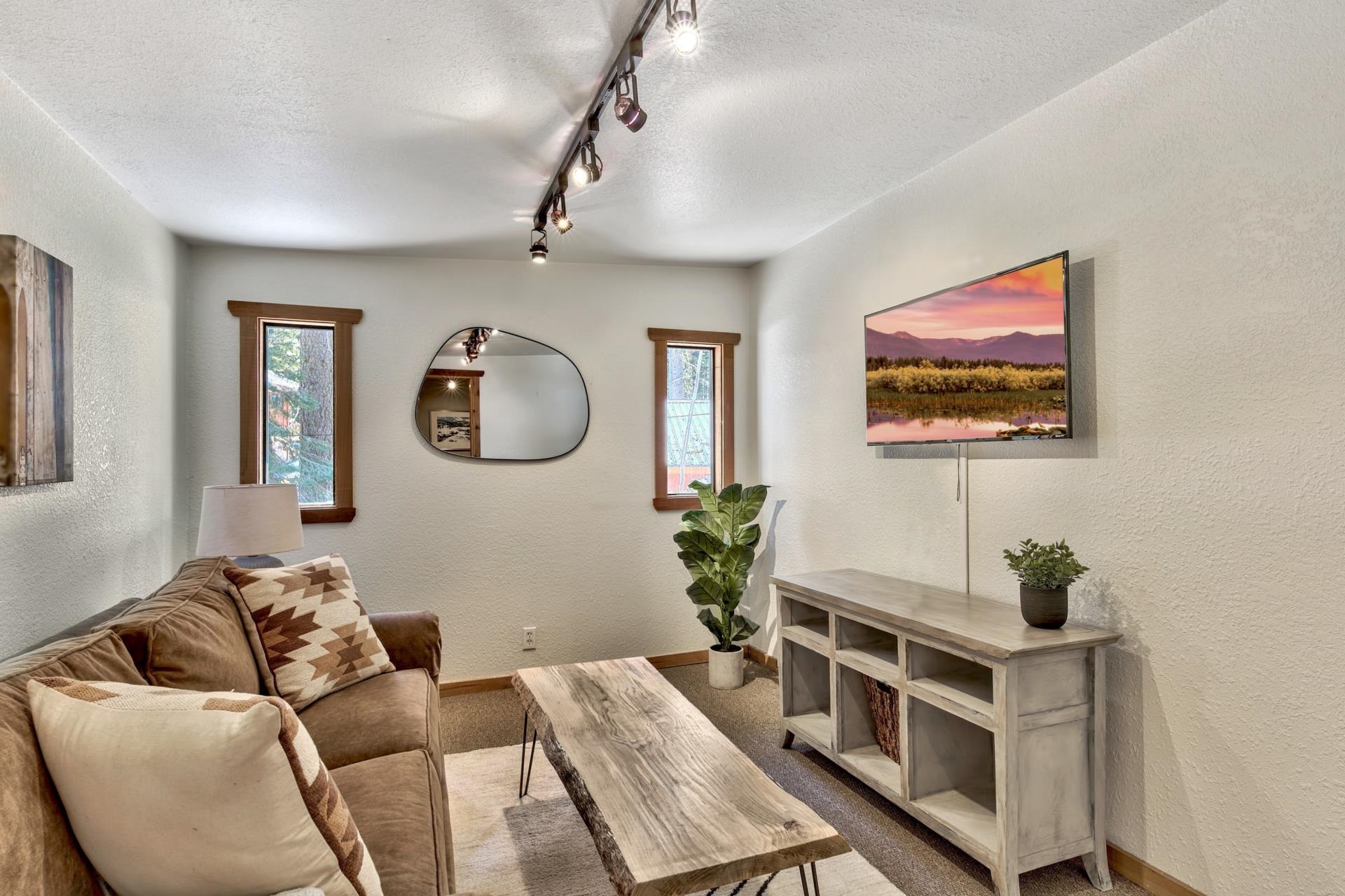 10101 Gregory Place Truckee, CA 96161 - Photo 17 of 21 a living room with furniture a mirror potted plant and a window