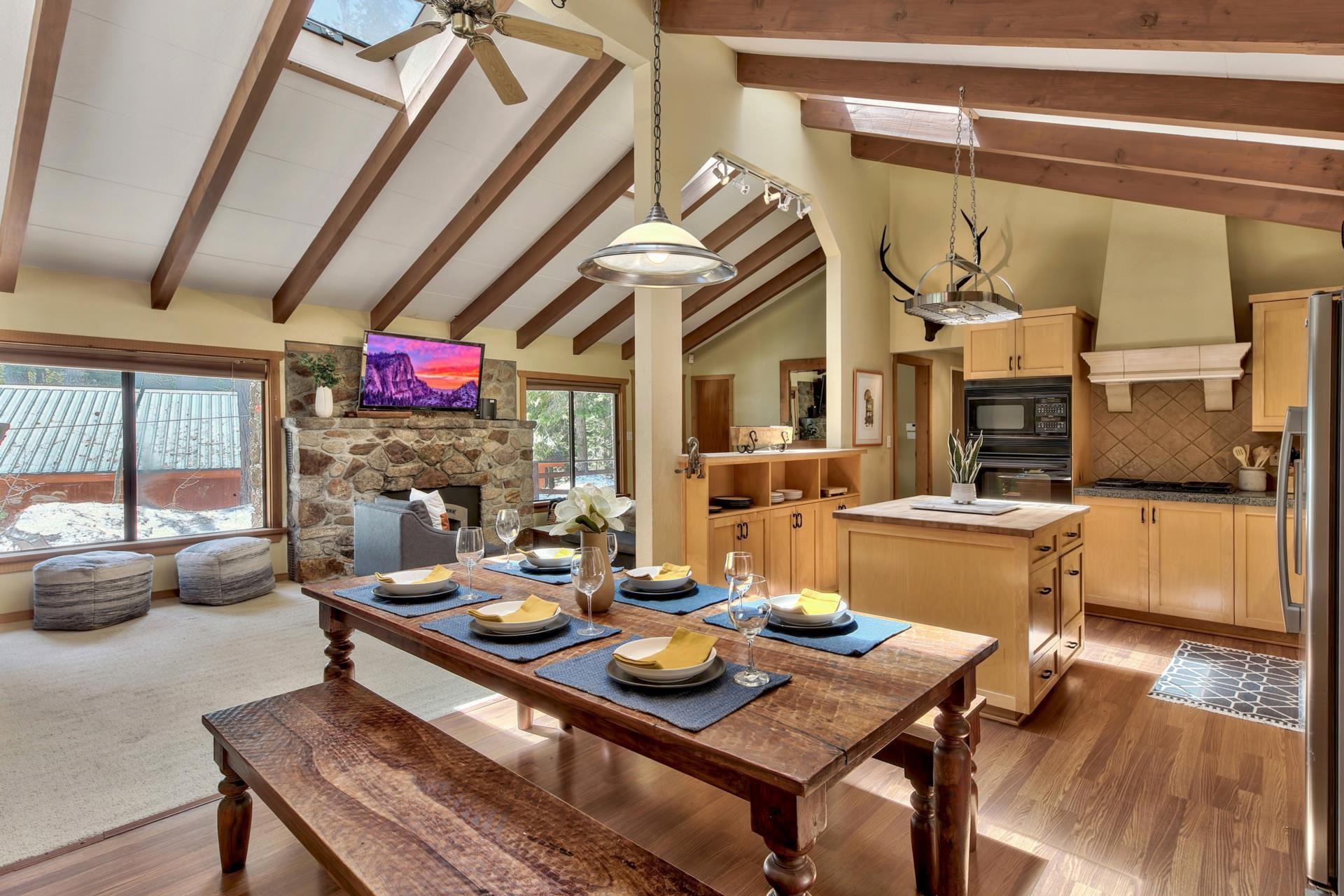 10101 Gregory Place Truckee, CA 96161 - Photo 10 of 21 a view of a dining room with furniture wooden floor and a chandelier