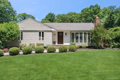 a view of a house with a yard and plants
