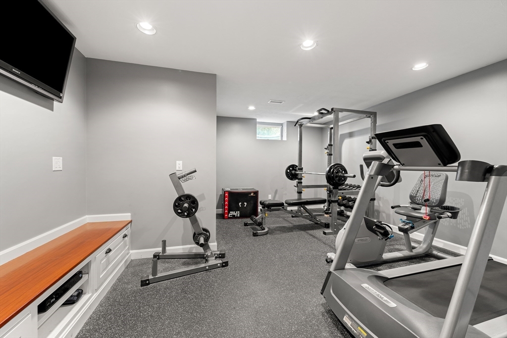219 A Ipswich Road Boxford, MA 01921 - Photo 33 of 41 a room with gym equipment and wooden floor
