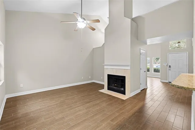 a view of a livingroom with wooden floor and a fireplace