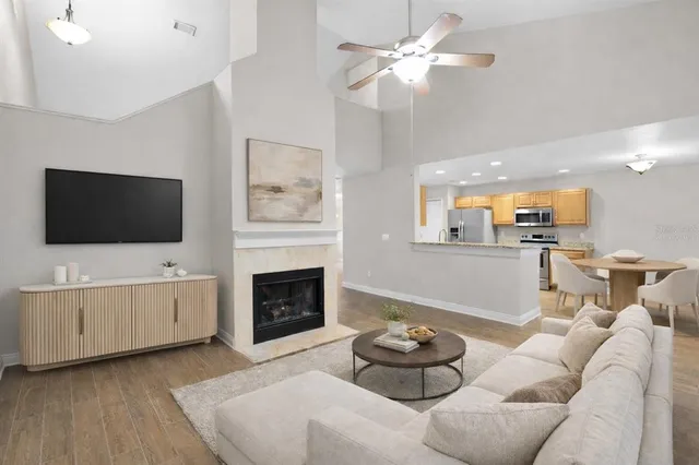 a living room with furniture fireplace and flat screen tv