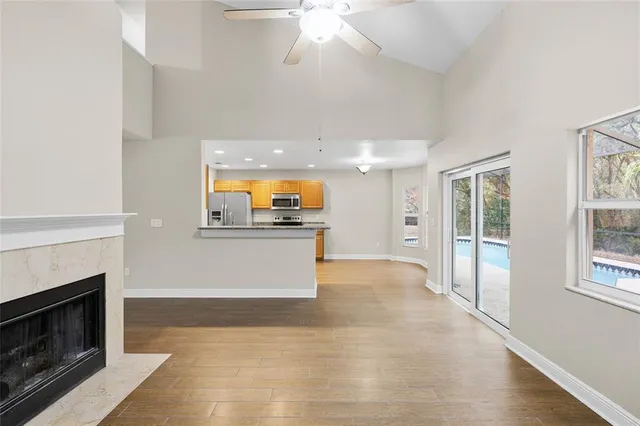 a view of kitchen with cabinets and fireplace