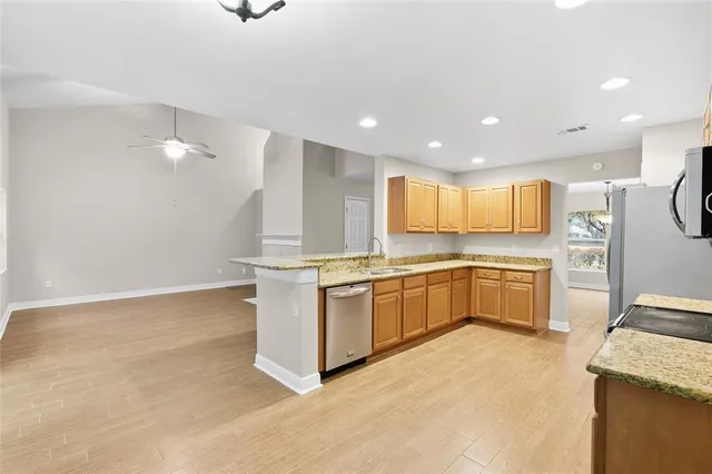 a large kitchen with a large counter top appliances and cabinets