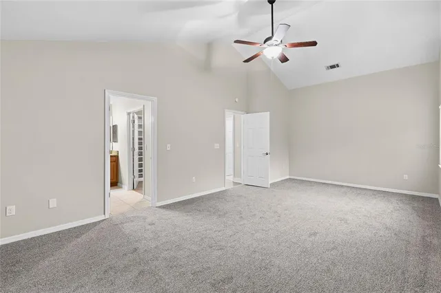 a view of an empty room with a ceiling fan