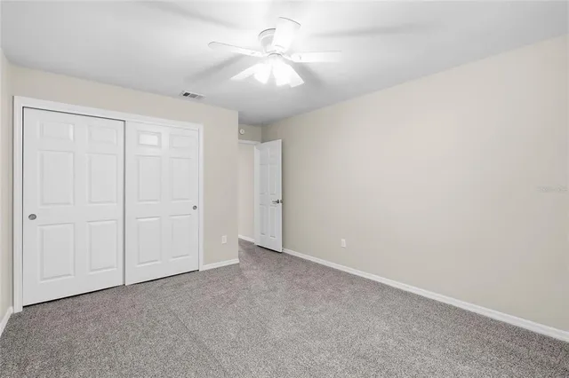 a bathroom with a granite countertop sink a toilet and bathtub