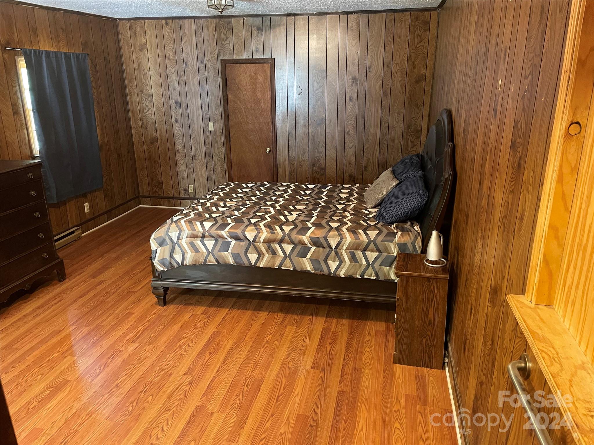 2508 Dora Drive Charlotte, NC 28215 - Photo 11 of 18 a bedroom with a bed and a dresser