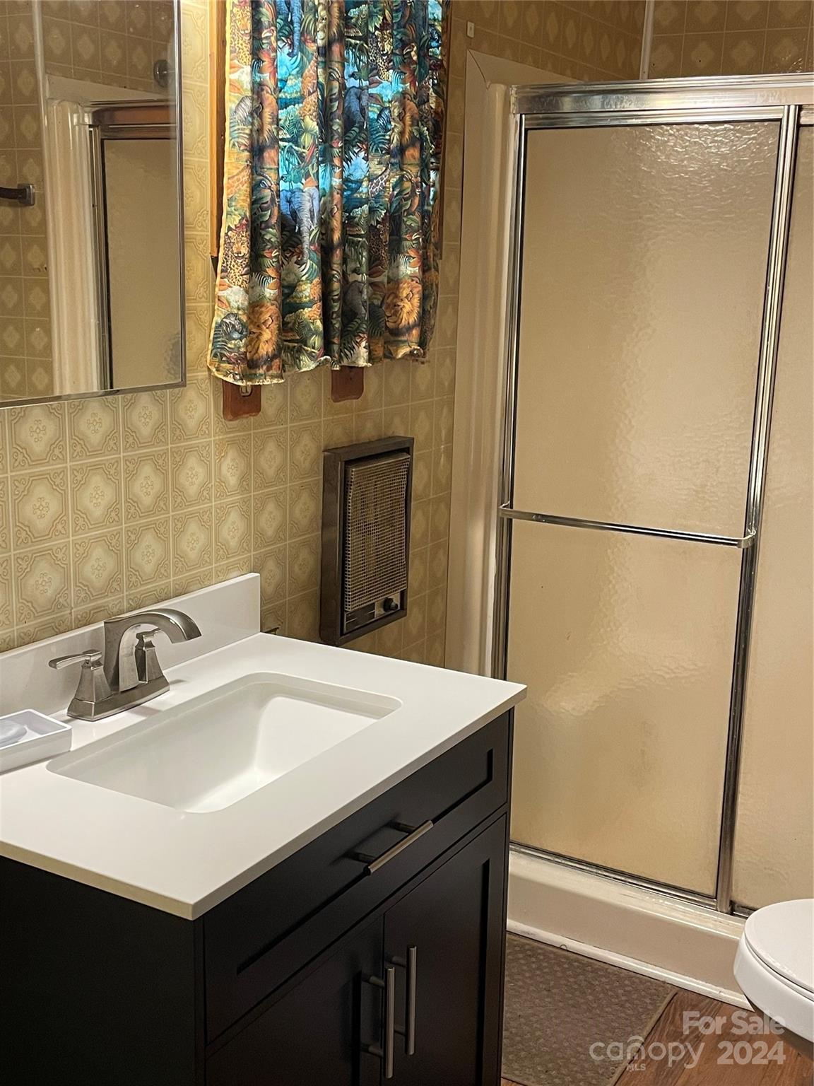 2508 Dora Drive Charlotte, NC 28215 - Photo 12 of 18 a bathroom with a sink and a mirror