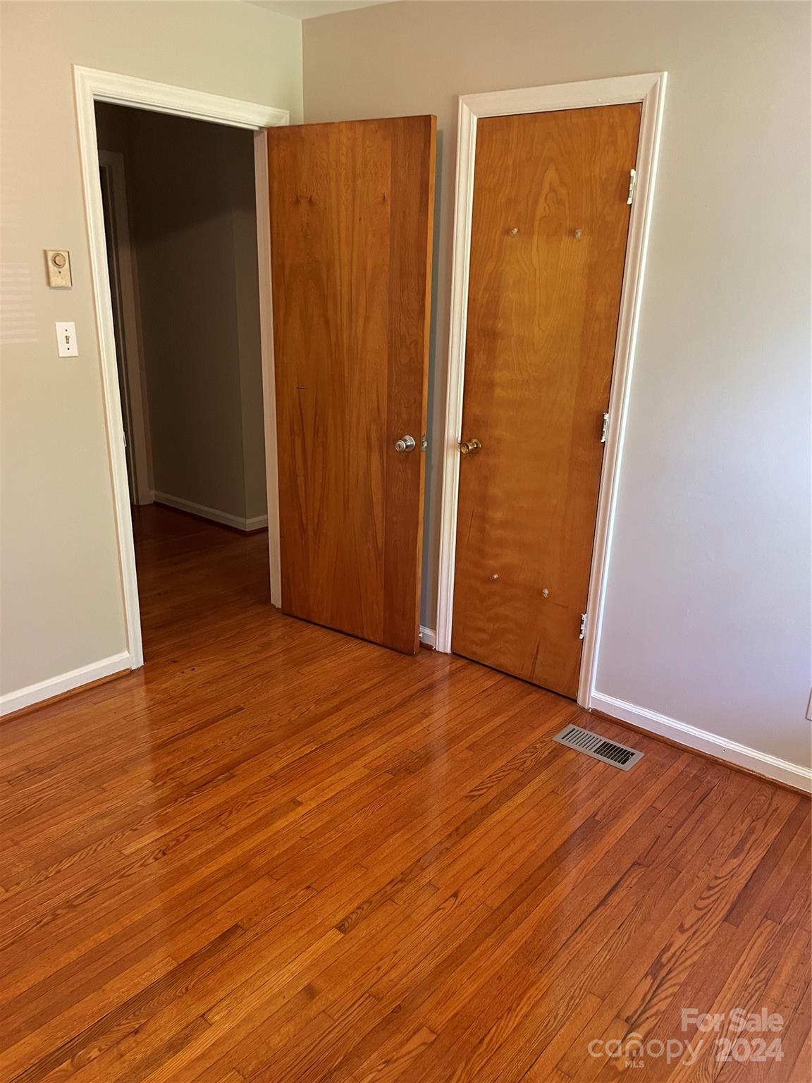 2508 Dora Drive Charlotte, NC 28215 - Photo 5 of 18 an empty room with wooden floor and closet