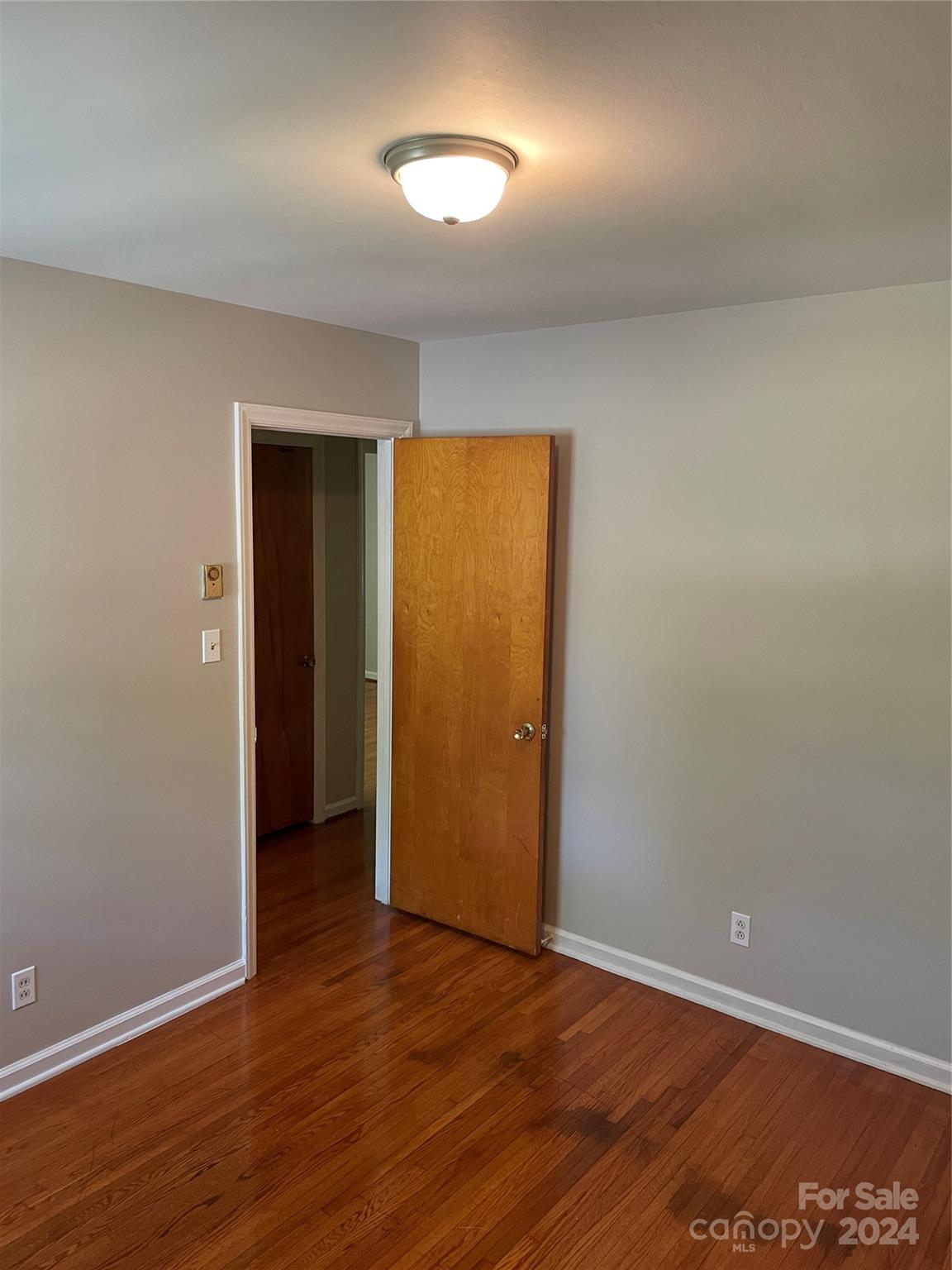 2508 Dora Drive Charlotte, NC 28215 - Photo 7 of 18 an empty room with wooden floor and windows