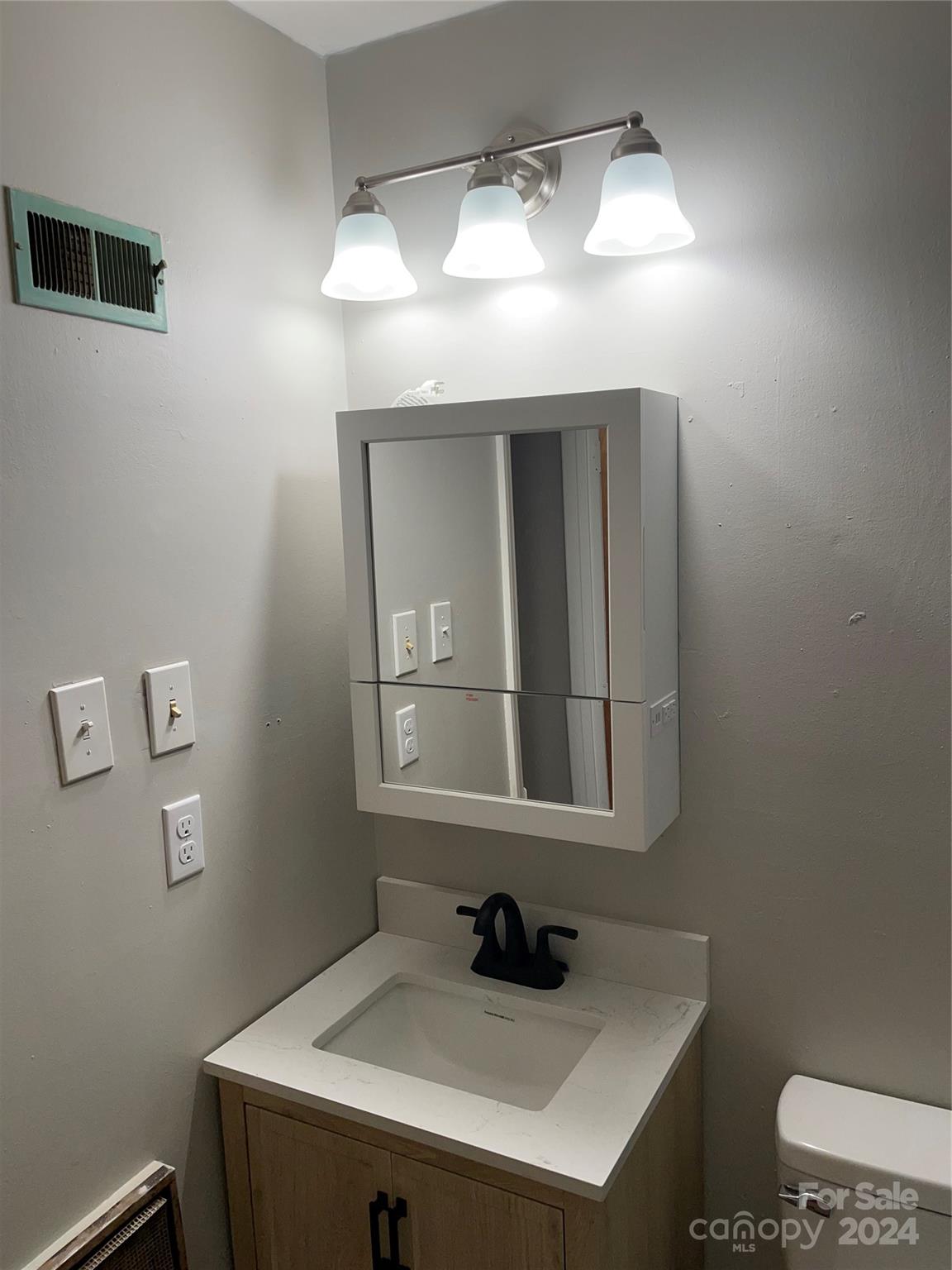 2508 Dora Drive Charlotte, NC 28215 - Photo 8 of 18 a bathroom with a sink and a mirror