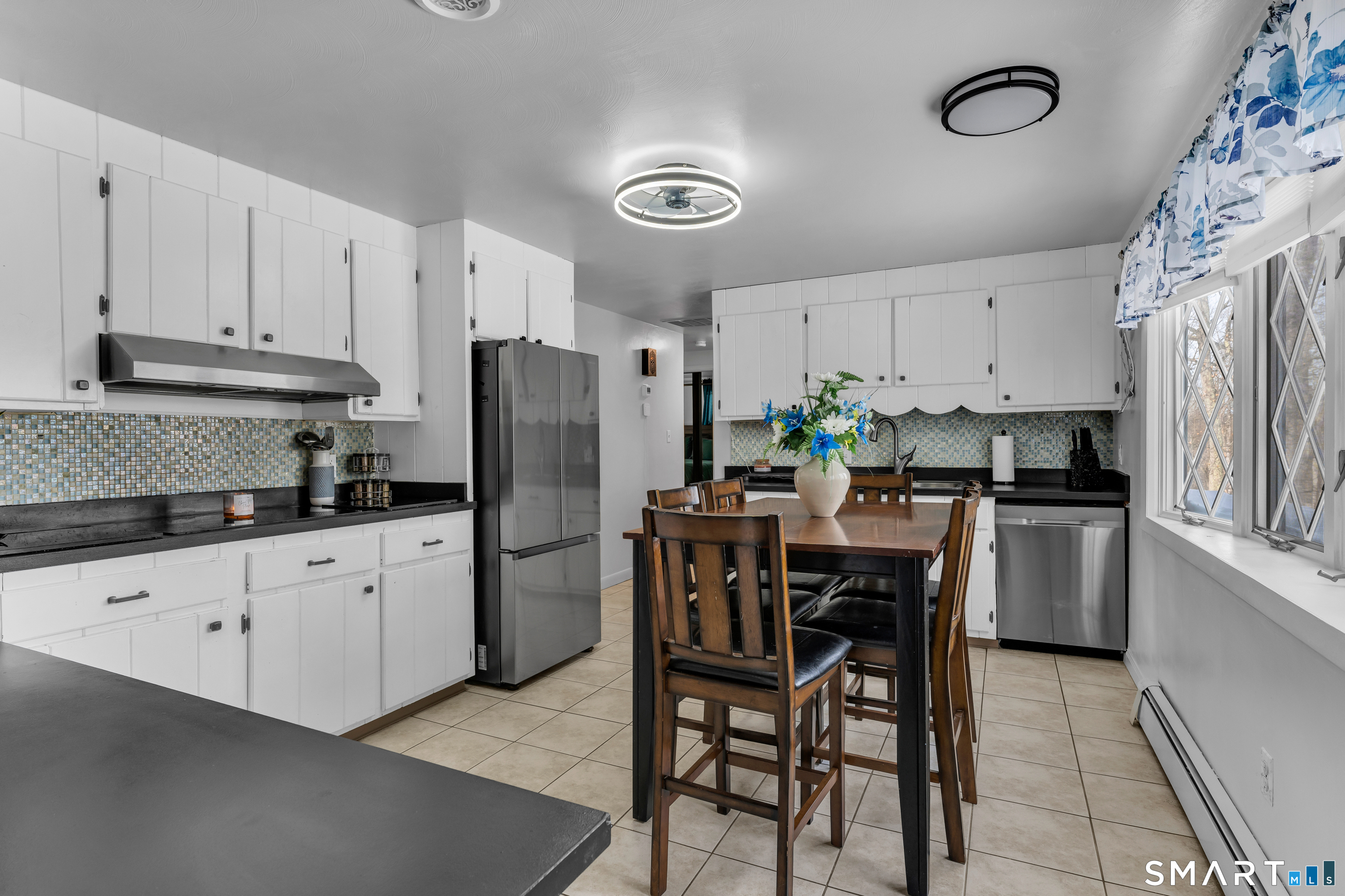 3 Hilltop Drive Ledyard, CT 06339 - Photo 12 of 34 a kitchen with refrigerator cabinets dining table and chairs