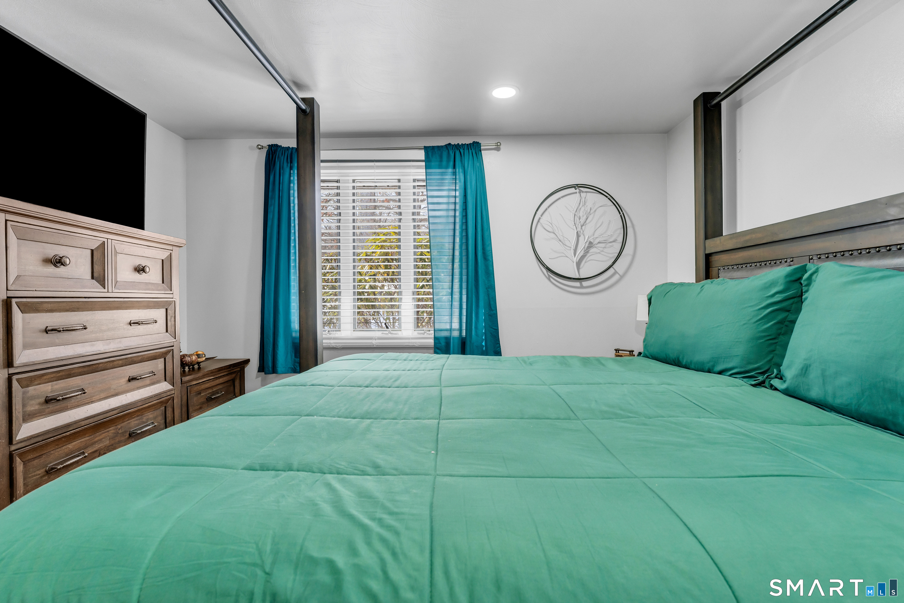 3 Hilltop Drive Ledyard, CT 06339 - Photo 17 of 34 a bedroom with a large bed and a flat tv screen on dresser