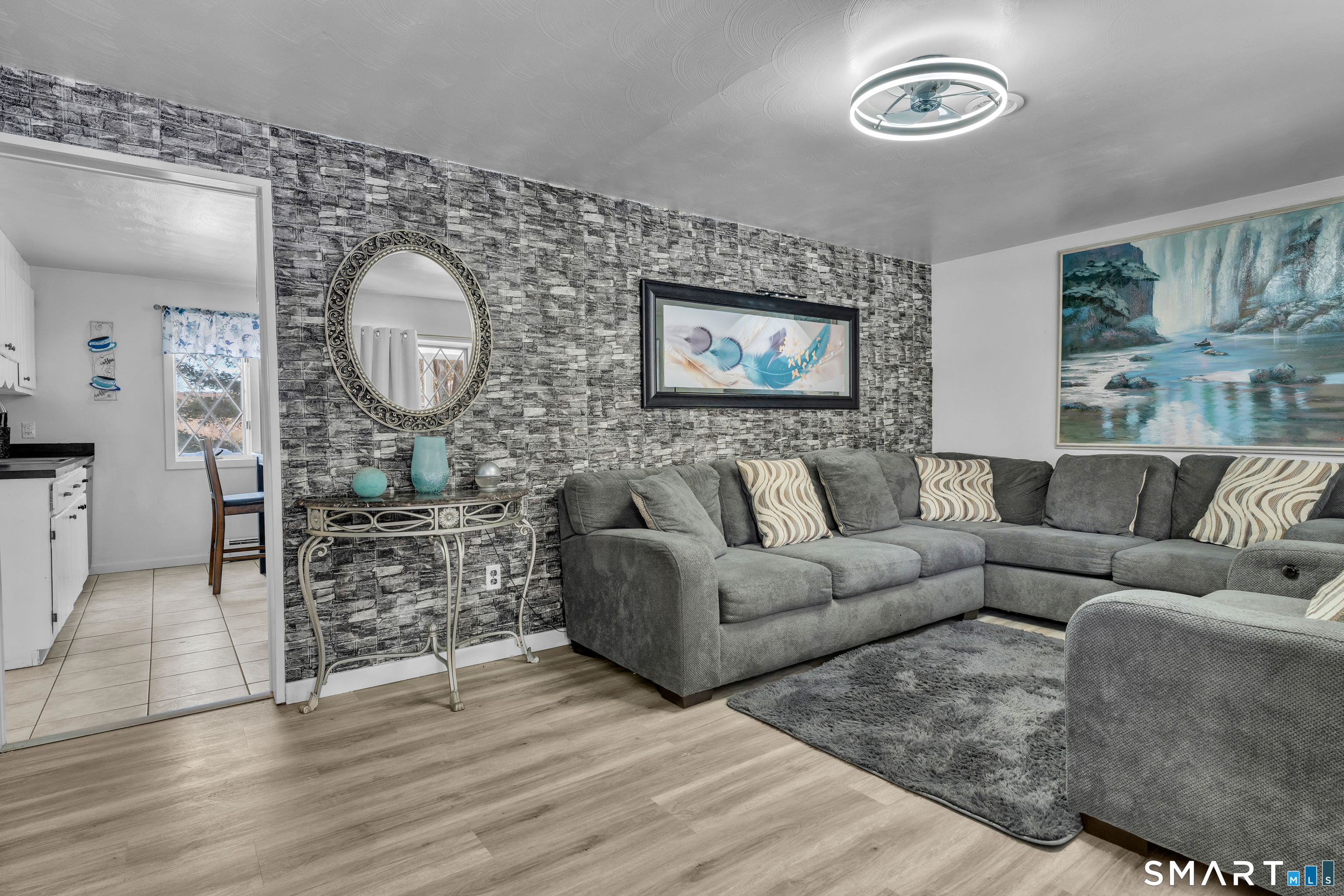 3 Hilltop Drive Ledyard, CT 06339 - Photo 7 of 34 a living room with furniture a large window and wooden floor
