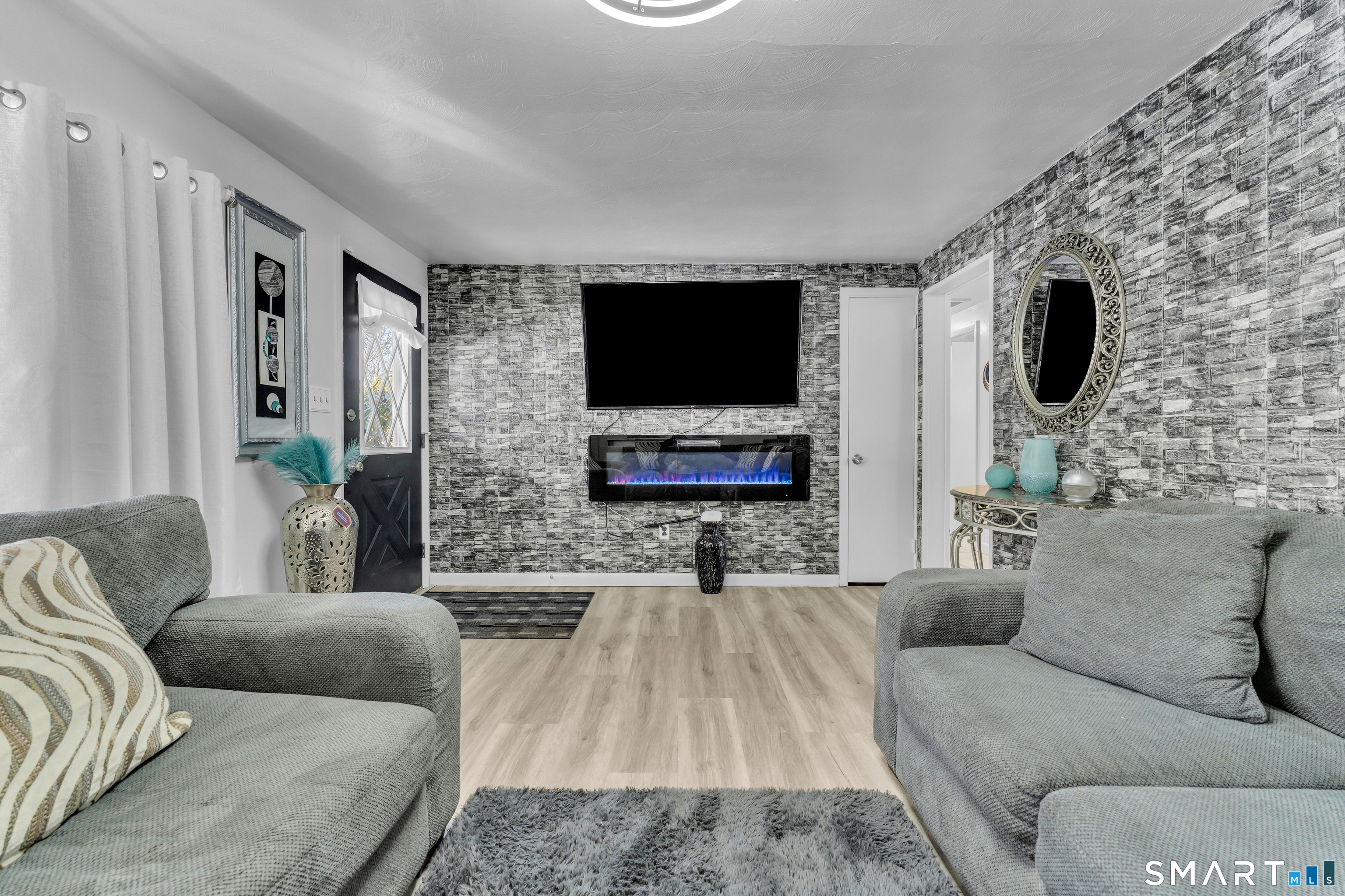 3 Hilltop Drive Ledyard, CT 06339 - Photo 10 of 34 a living room with furniture and a flat screen tv