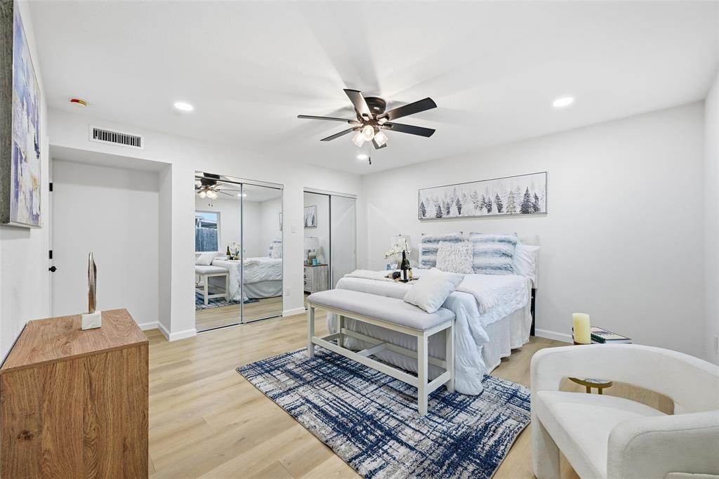 4840 Graham Court The Colony, TX 75056 - Photo 13 of 23 a bedroom with a bed and a chandelier