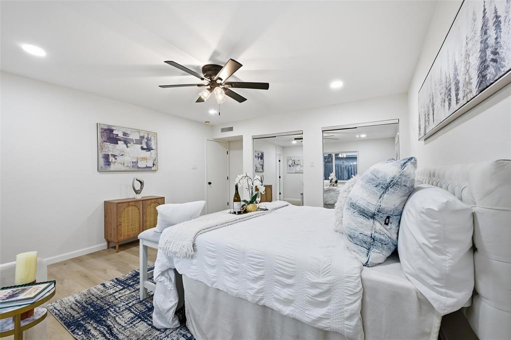 4840 Graham Court The Colony, TX 75056 - Photo 14 of 23 a large bedroom with a bed and wooden floor