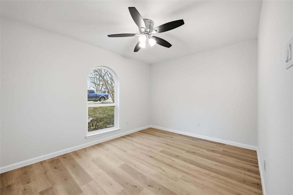 4840 Graham Court The Colony, TX 75056 - Photo 17 of 23 an empty room with a window and ceiling fan