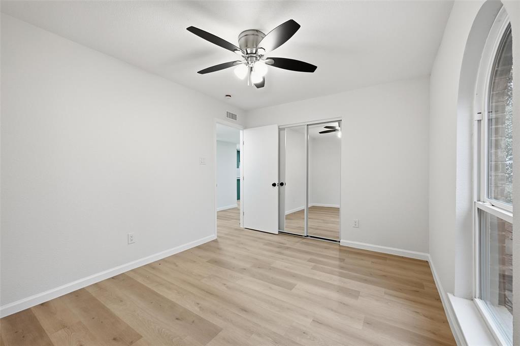 4840 Graham Court The Colony, TX 75056 - Photo 19 of 23 an empty room with wooden floor and ceiling fan
