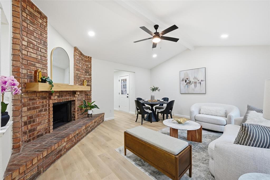 4840 Graham Court The Colony, TX 75056 - Photo 3 of 23 a living room with furniture and a fireplace
