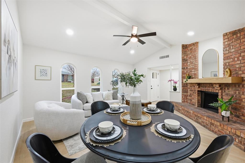 4840 Graham Court The Colony, TX 75056 - Photo 7 of 23 a dining room with furniture a fireplace and wooden floor