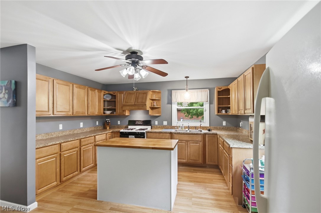 2591 Wayland Road Deerfield, OH 44411 - Photo 8 of 46 Kitchen featuring wood-finish flooring, a central island with a butcher block countertop, ample cabinetry, and a ceiling fan with integrated lighting
