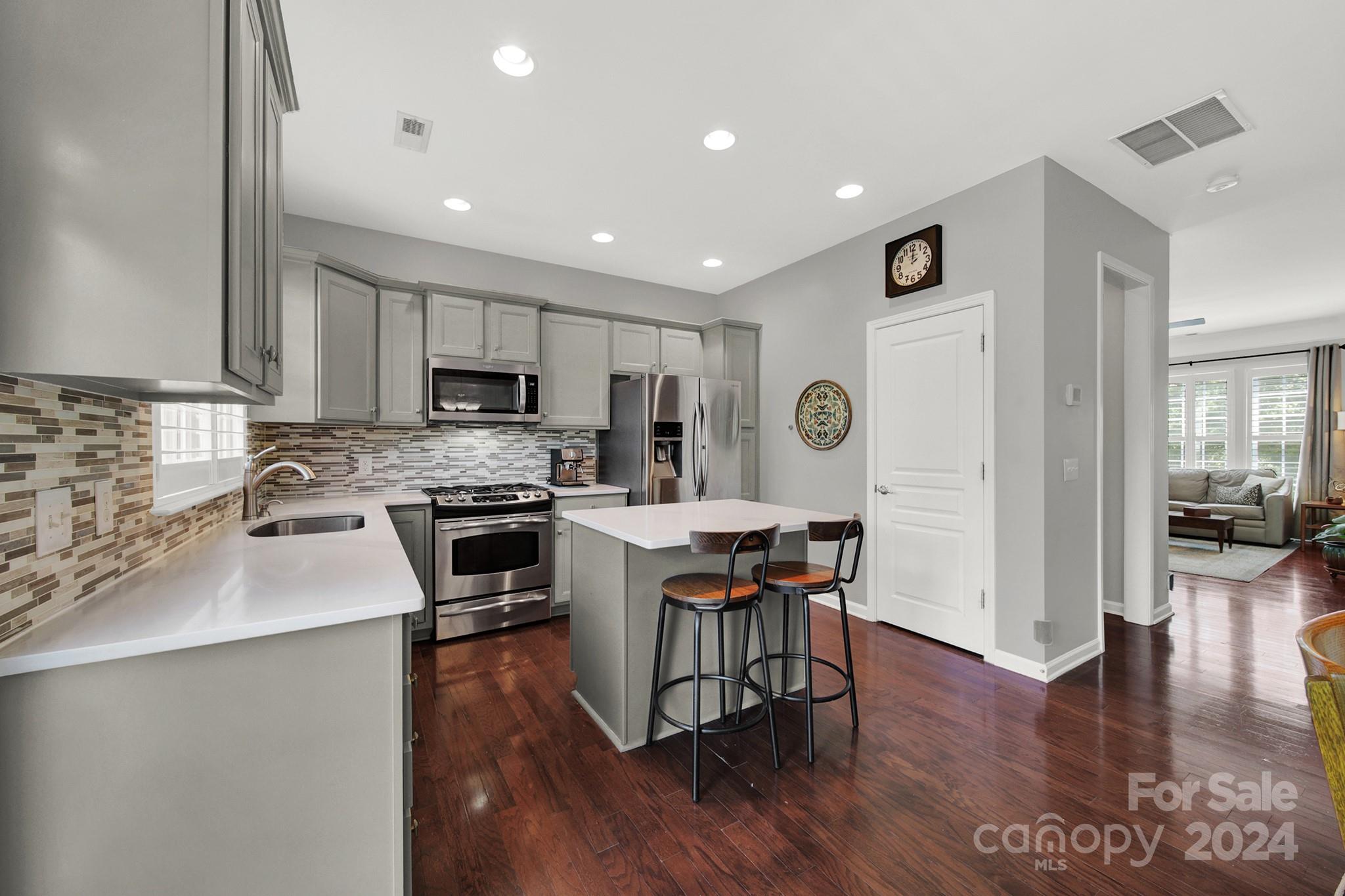 581 6th Baxter Crossing Fort Mill, SC 29708 - Photo 12 of 30 a kitchen with a sink a counter top space stainless steel appliances and cabinets
