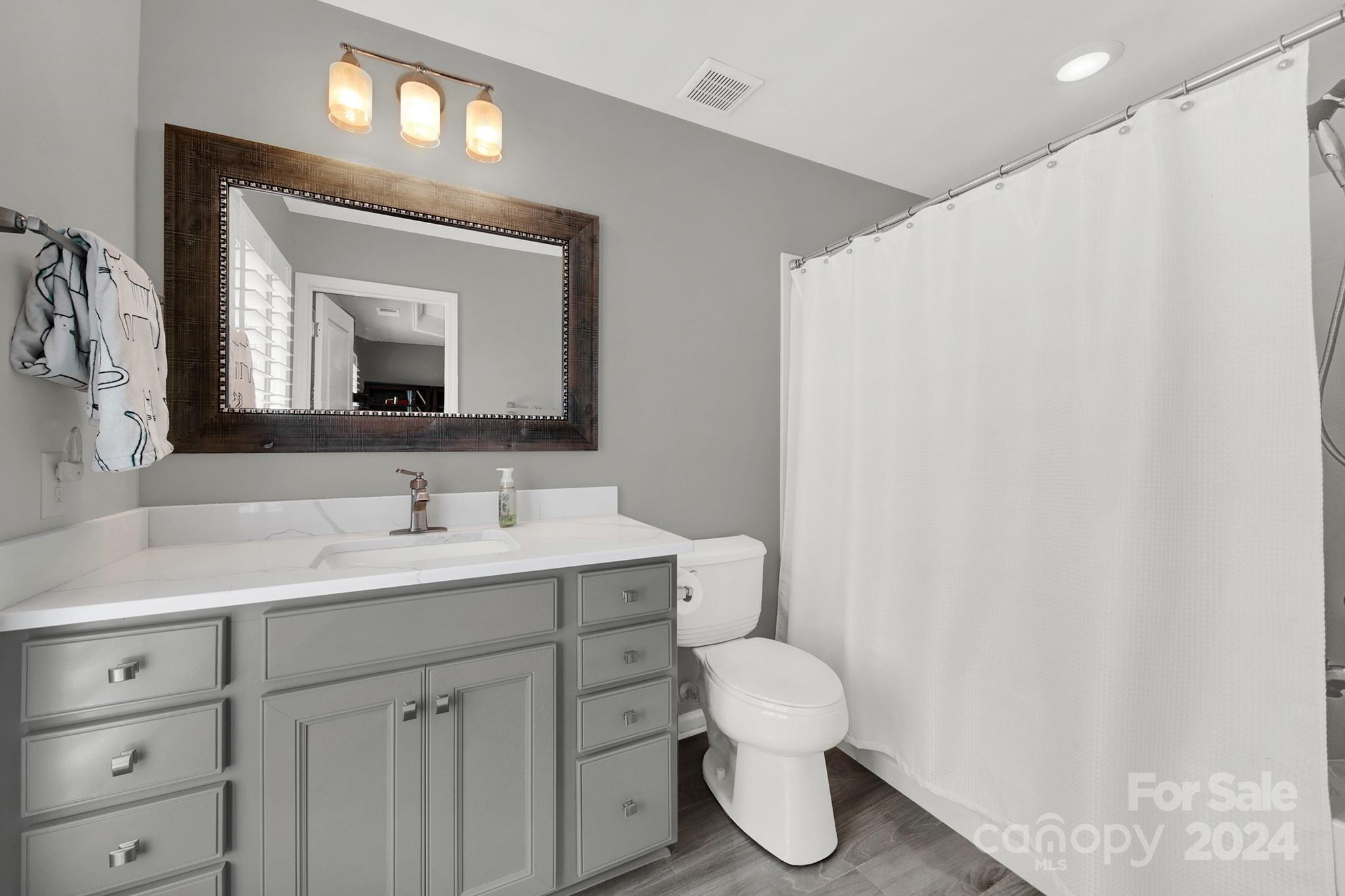 581 6th Baxter Crossing Fort Mill, SC 29708 - Photo 16 of 30 a bathroom with a toilet sink and mirror