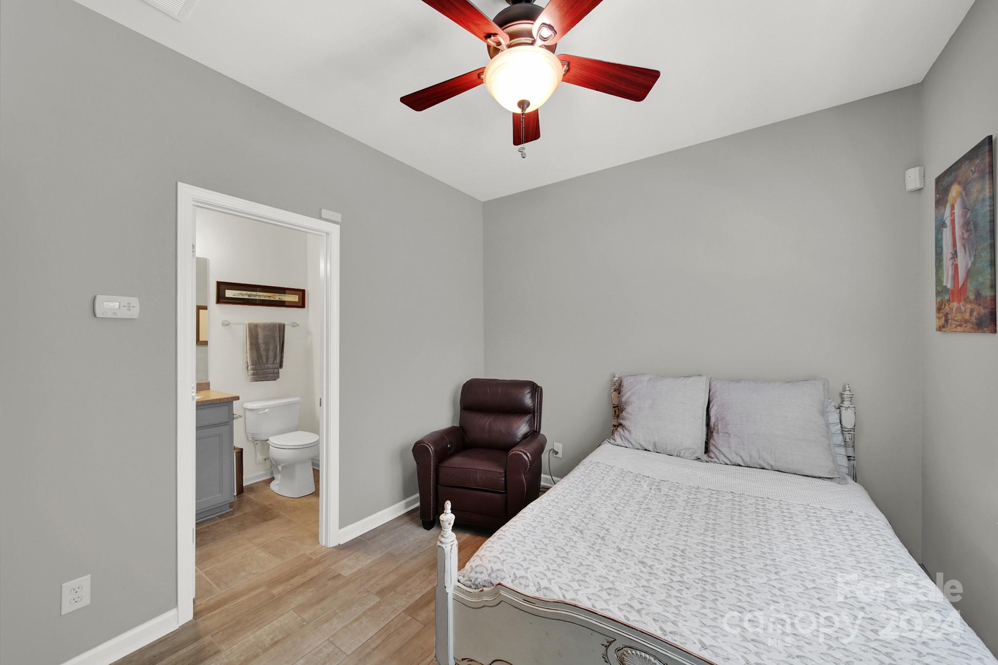 581 6th Baxter Crossing Fort Mill, SC 29708 - Photo 24 of 30 a bedroom with a bed and a chandelier