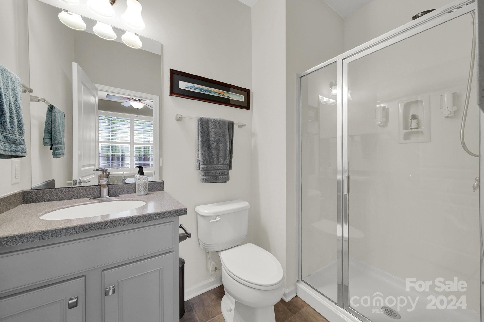 581 6th Baxter Crossing Fort Mill, SC 29708 - Photo 25 of 30 a bathroom with a granite countertop sink toilet and shower