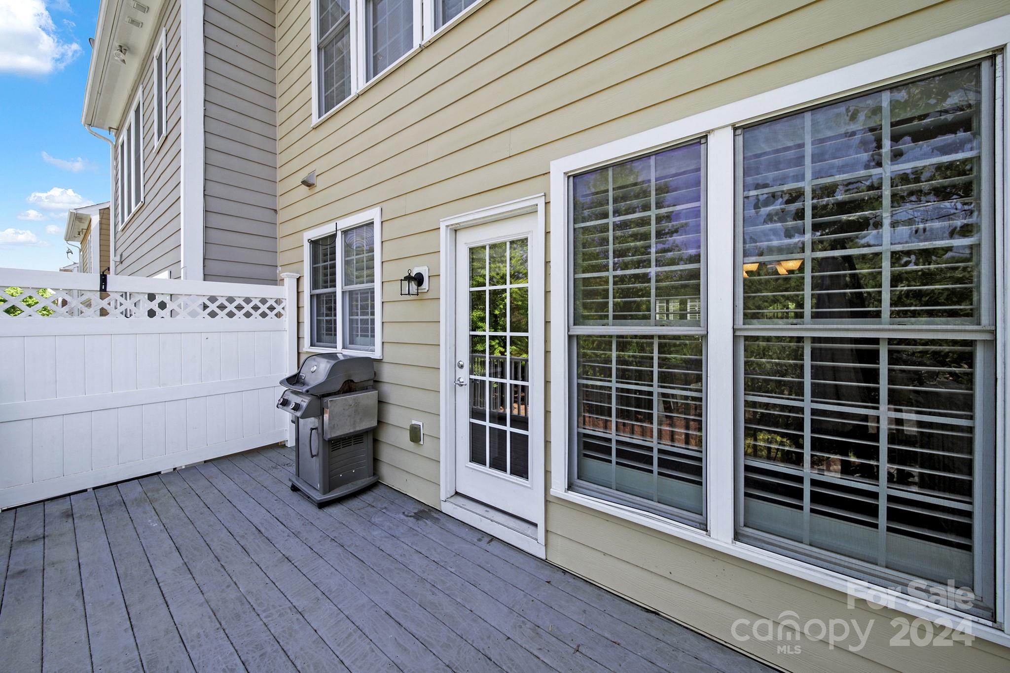 581 6th Baxter Crossing Fort Mill, SC 29708 - Photo 28 of 30 a view of a deck with table and chairs and wooden floor