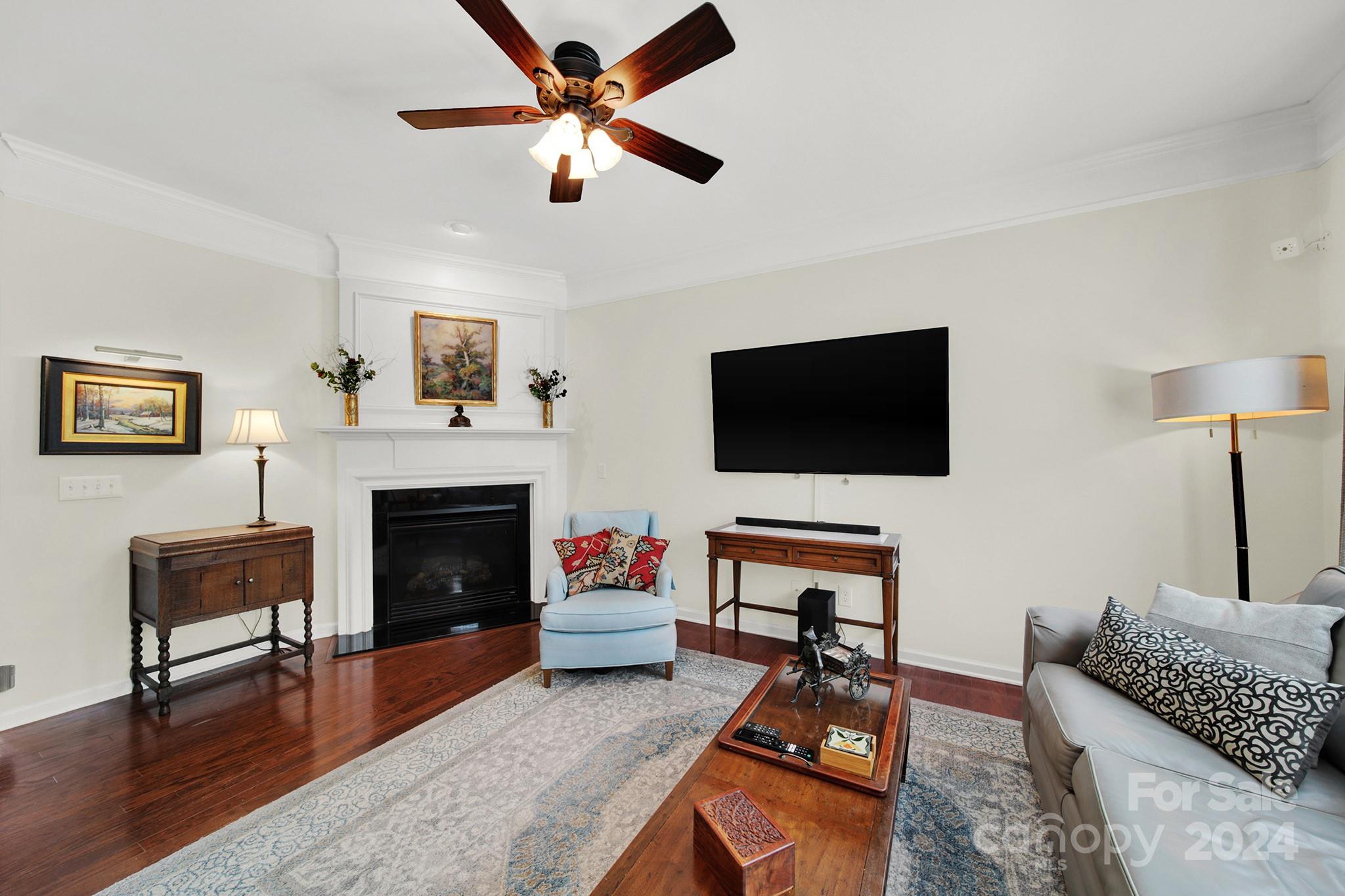 581 6th Baxter Crossing Fort Mill, SC 29708 - Photo 7 of 30 a living room with furniture a flat screen tv and a fireplace