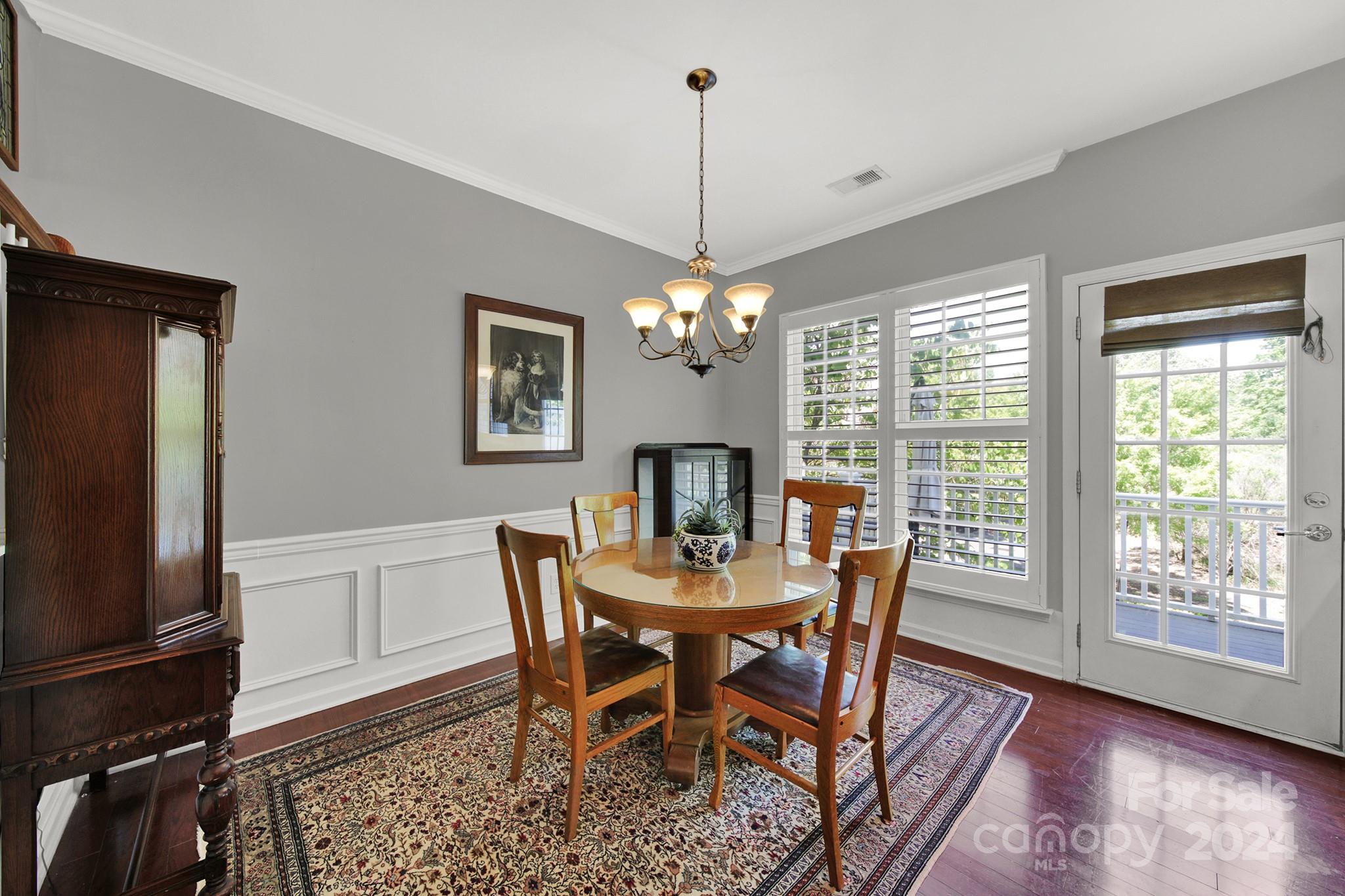 581 6th Baxter Crossing Fort Mill, SC 29708 - Photo 8 of 30 a dining room with furniture a chandelier and wooden floor