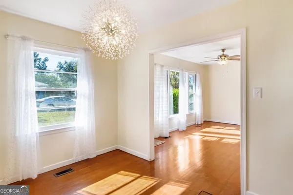 a kitchen with stainless steel appliances granite countertop a sink a stove a refrigerator and cabinets